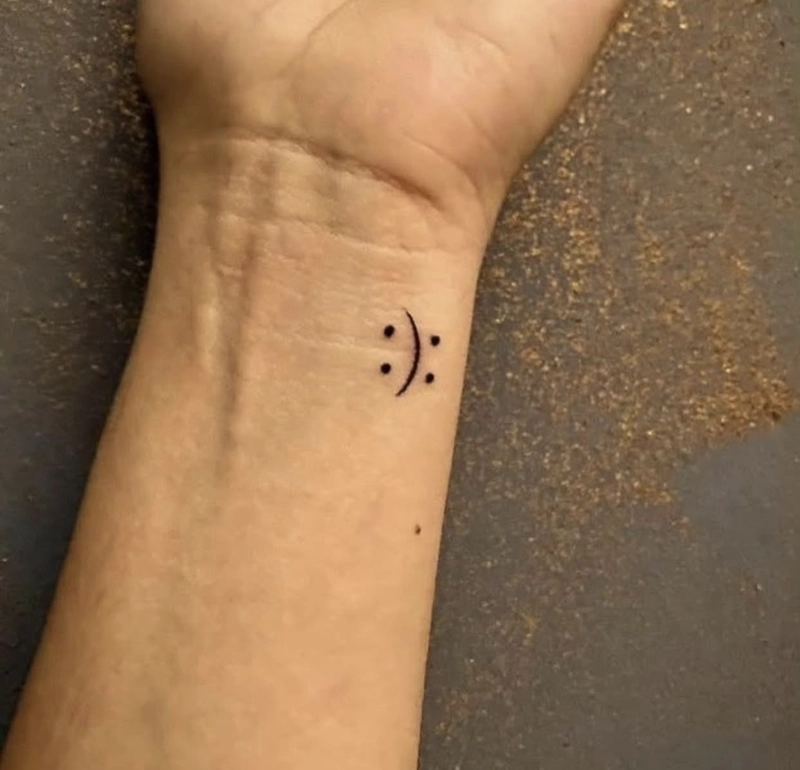 Hình xăm cổ tay mặt cười